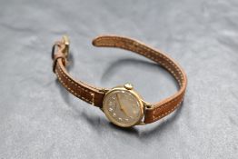A lady's 9ct gold wrist watch by Tissot having Arabic numeral dial to champagne face in plain case