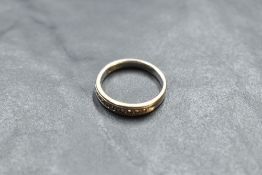 A 14ct gold diamond set eternity/wedding ring having ten small diamonds within a channel mount, size