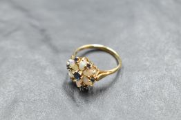 An opal and sapphire daisy cluster (missing a small sapphire) in a claw set basket mount on a 14ct