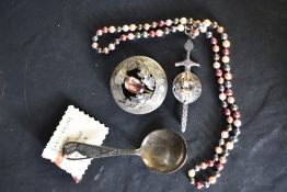 An HM silver christening spoon bearing a stork to terminal, Chester 1956, two Celtic silver brooches