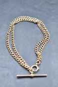A 9ct rose gold double chain bracelet having attached T bar, approx 14.8g