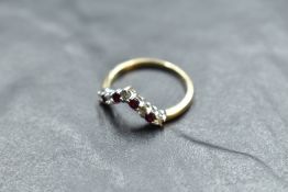 A diamond and garnet set 9ct gold wishbone ring, size Q & approx 2.6g