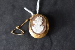 A small conch shell cameo brooch depicting the Greek goddess of the moon, Selene in a 9ct gold