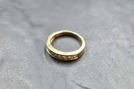 A nine stone diamond half eternity ring, total approx 0.75ct in a channel setting on an 18ct