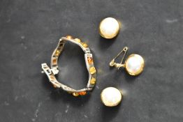 A Polish silver articulated bracelet having five Baltic amber set panels, and a simulated split