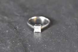 A four stone princess cut diamond ring, total approx 0.37ct in a four claw collared basket mount