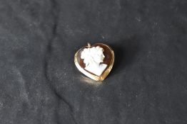 A conche shell heart shaped cameo brooch/pendant depicting a maiden in profile in an 18ct gold