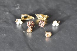 Four pairs of 9ct gold earrings of various forms including seed pearl, garnet, knot, 3 pairs stud, 1