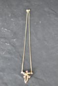 A 9ct gold knot style pendant with ruby detail and a fixed chain, approx 16' & 2.7g