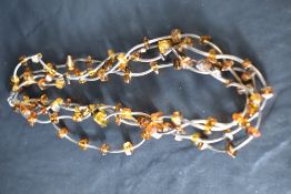 A four strand silver and amber collarette necklace