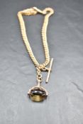 A 9ct rose gold graduated curb link watch chain with T bar and fob having smoky quartz stone, approx