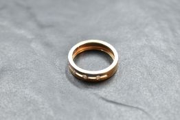 A 750 grade yellow and white metal diamond set ring, the open platform pressure set with five