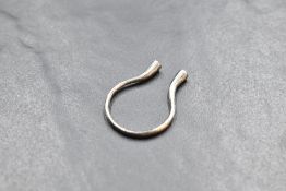 An 18ct gold ring by Fei Lui of stylised open form having diamond and citrine set terminals, size