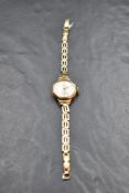 A ladies 9ct gold wrist watch by Avia having an arabic numeral dial with subsidiary seconds in a
