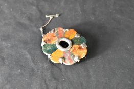 A Victorian Scottish mixed agate and silver brooch having an ebony style back and silver frame