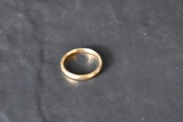 A yellow metal wedding band, no marks, presumed gold, size S & approx 4.8g