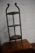 An early 20th Century oak folding cake stand