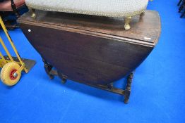 An early to mid 20th Century oak drop leaf dining table