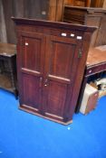 A George III oak wall corner cupboard