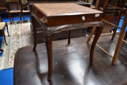 A traditional oak nest of three tables