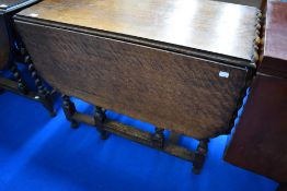 An early 20th Century oak pie crust twist gate leg dining table