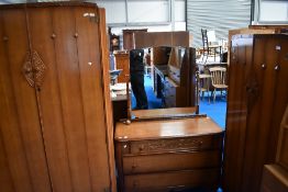 A mid 20th century oak three-piece 'Austinsuite' bedroom suite, comprising large double door