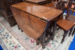 A period oak drop leaf dining table having turned gate legs