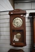 An early 20th Century oak cased wall clock