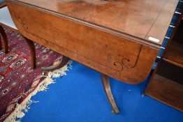 A Victorian tea table in an Aesthetic style with drop leaf and under drawers