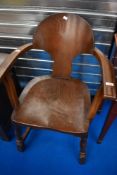 An interesting mid 20th Century part oak carver chair having ply back and solid seat on turned