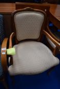 A reproduction Continental style stained frame armchair