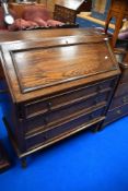 An early 20th Century oak bureau having barley twist frame