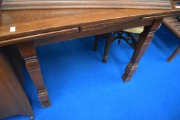 An early 20th Century oak drawer leaf table