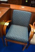 A vintage stained frame armchair, possibly Parker Knoll, with ater green and gold upholstery