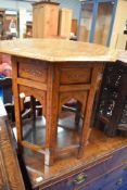 An Eastern style octagonal table with folding frame and brass inlay decoration