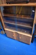 A golden oak bookcase with double cupboard under