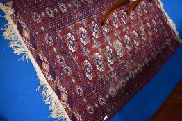 A Persian rug having red ground with shades of cream and blue, approx. 195 x 125cm