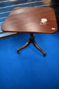 A 19th Century pedestal occasional table having square top on turned column and triple splay legs