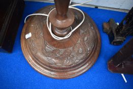 An Oriental carved standard lamp