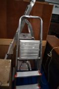 Three sets of aluminium steps, graduated sizes