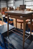 An Edwardian mahogany occasional table having fold over top