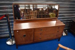 A vintage Remploy dressing table having three long drawers and cupboard to base