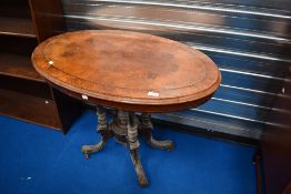 A 19th Century walnut occasional table having quarter veneered top, turned column and quadruple