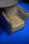 A vintage Lloyd Loom tub chair in gold