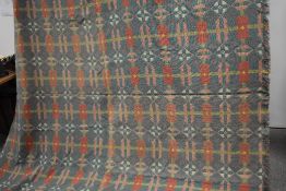 A Welsh blanket in pink, green, yellow and white colour way.