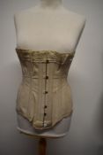 An early 20th century side sprung corset, having lace to top.