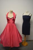 A 1950s cerise taffeta full circle halterneck dress, having black lace accents to bodice, sold