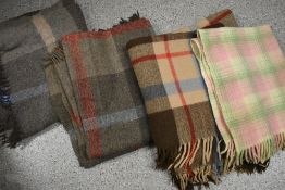 Three vintage tartan rugs and a cot or pram blanket.