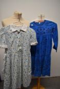 A mixed lot of childrens and babies clothing, including 1950s child's dress, 1970s blue dress and an