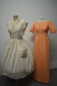 A 1950s white cotton shirtwaister, having orange embroidered stripes, large patch pocket with